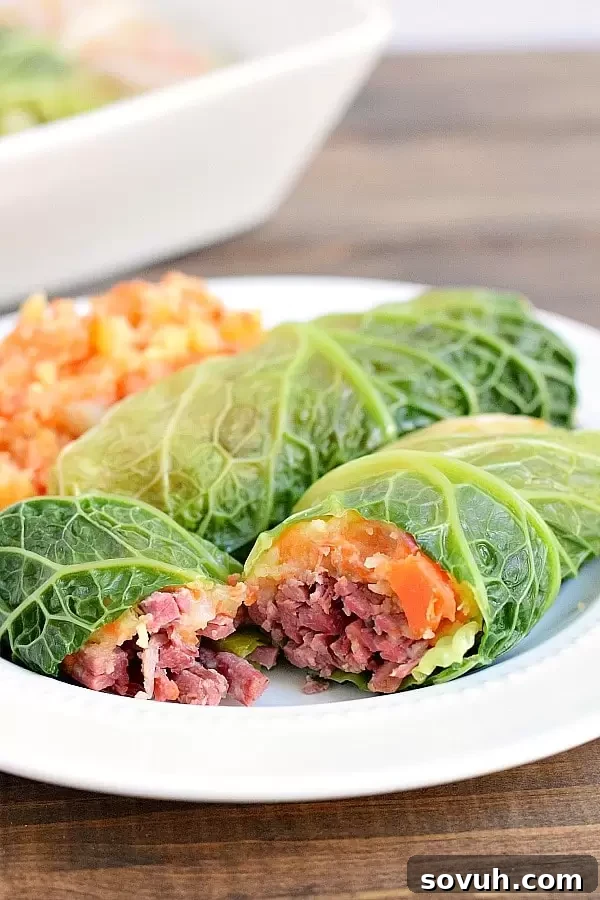 Two perfectly baked corned beef cabbage rolls resting on a plate, showcasing their golden-brown exterior and delicious filling.