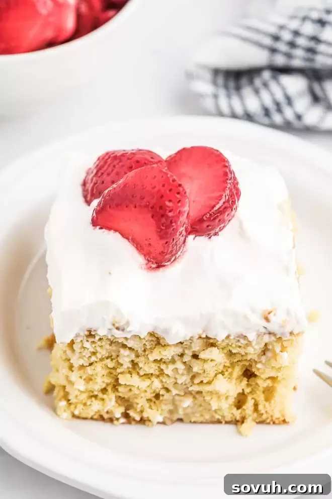 Tres Leches Cake with frosting and strawberries