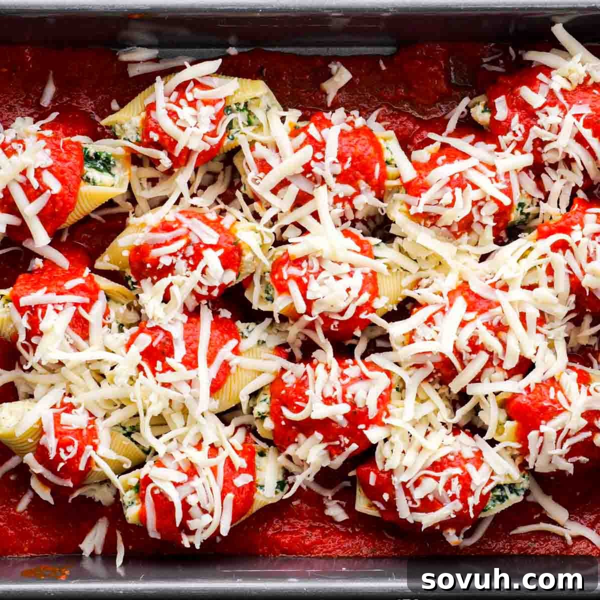 shredded mozzarella on top of Stuffed Shells