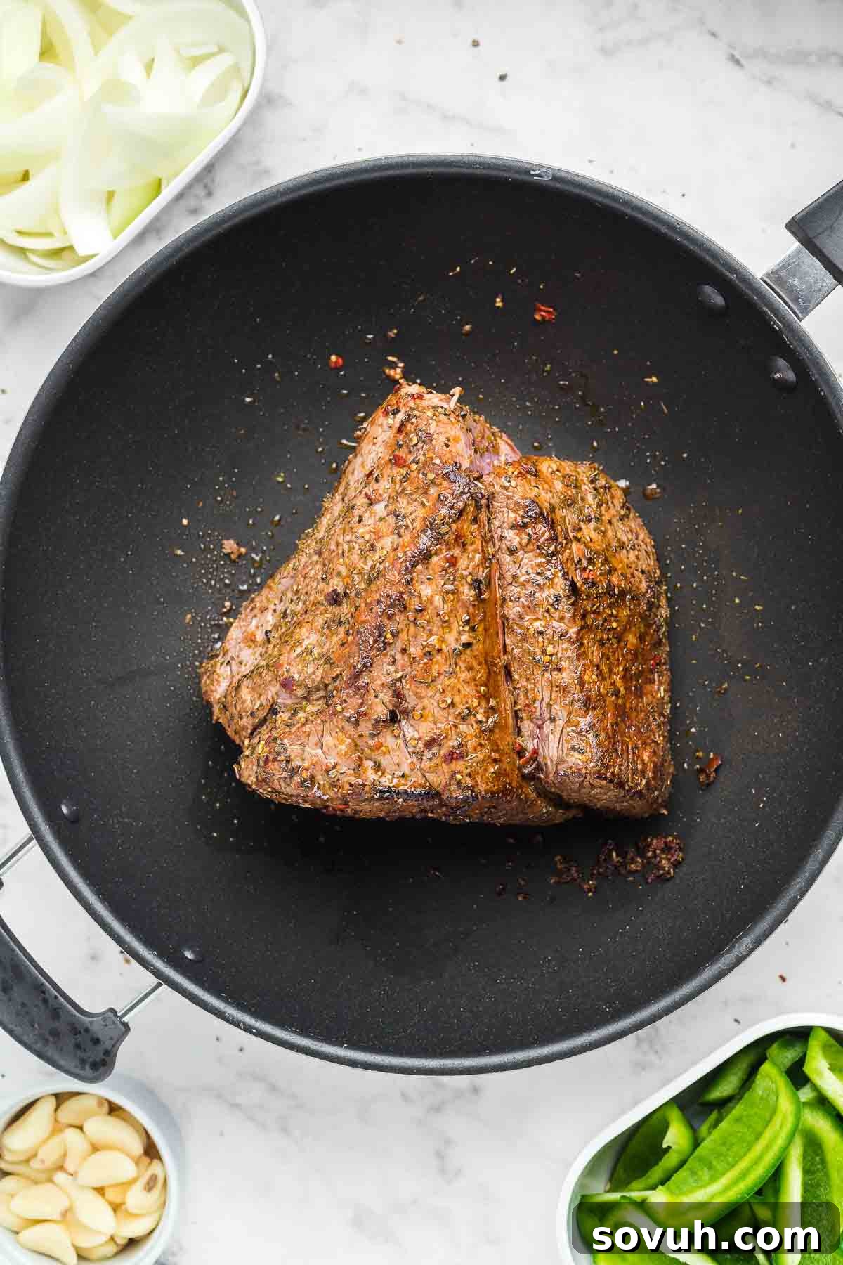 Searing Crock Pot Italian Beef in a cast iron skillet before slow cooking.