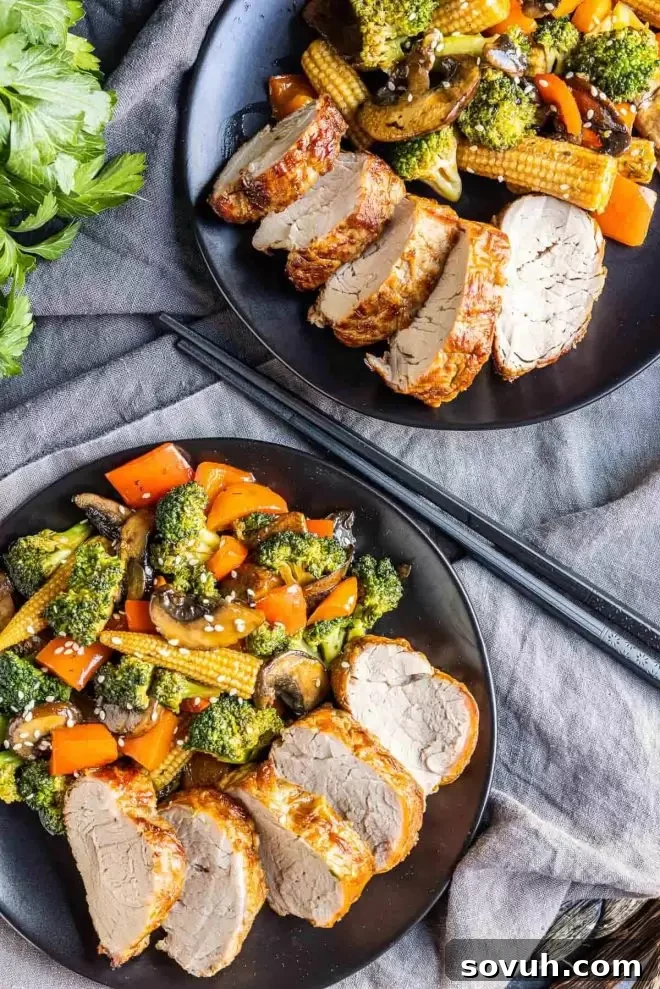 Air Fryer Pork Tenderloin with stir fry veggies on plates