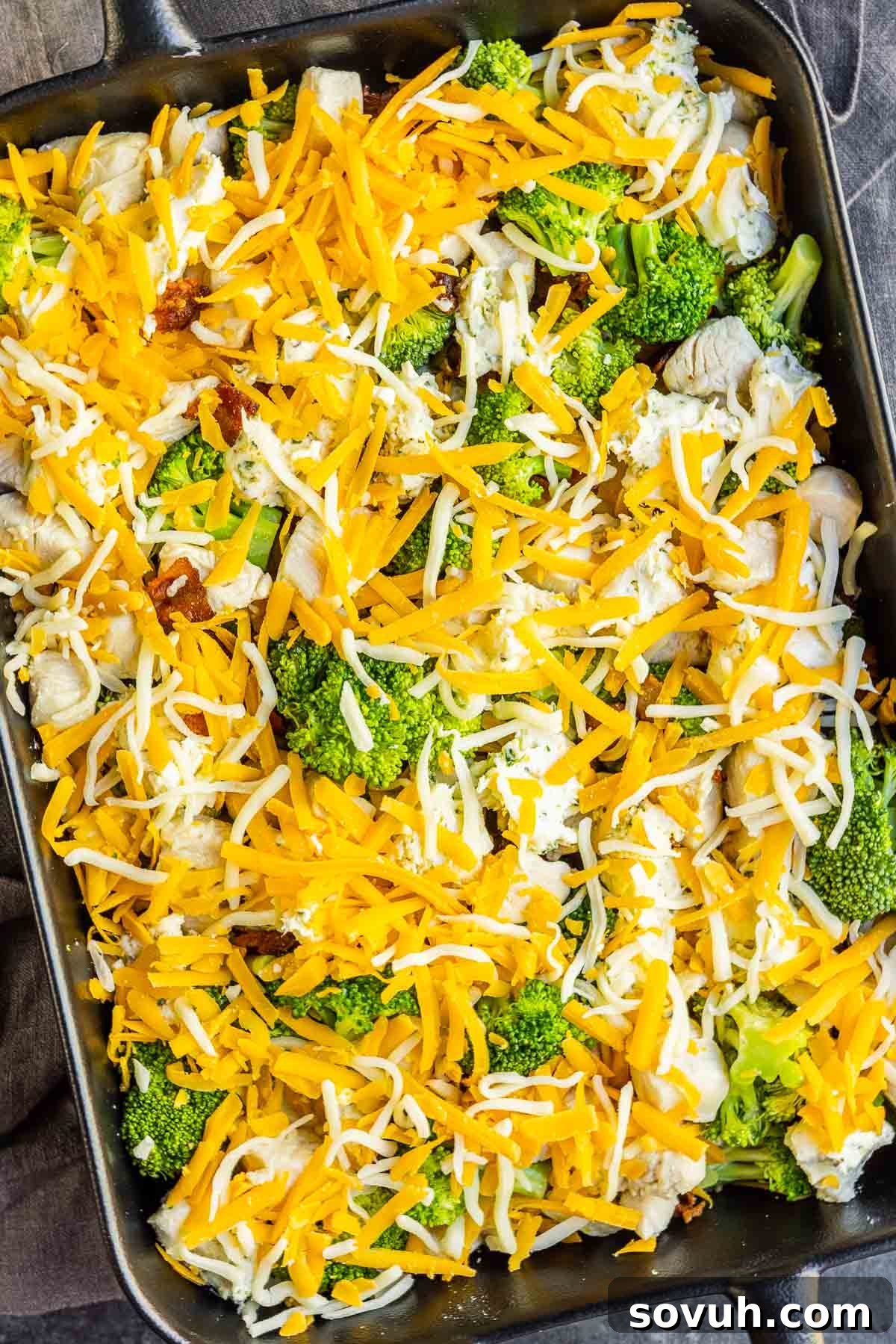 Step-by-step assembly of Keto Chicken Bacon Ranch Casserole, showing cooked chicken, steamed broccoli, mixed cream cheese and ranch seasoning, and shredded cheeses in a baking dish