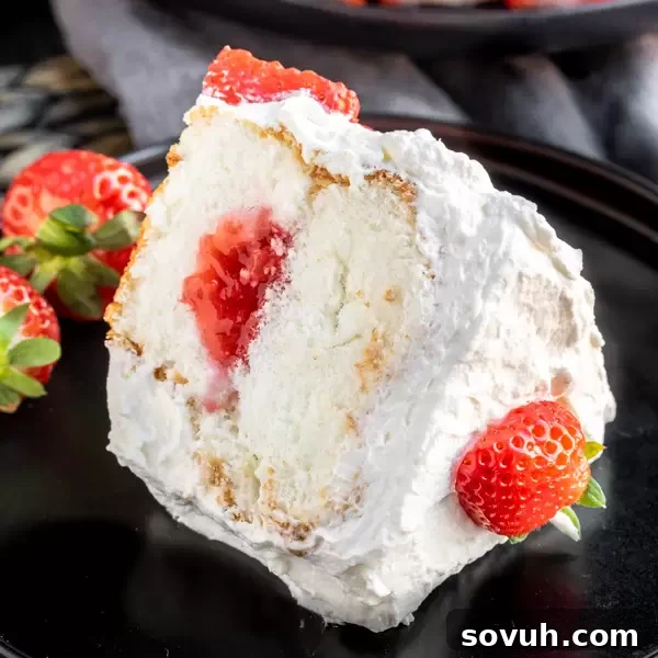 Light and airy Strawberry Angel Food Cake adorned with fresh strawberries, perfect for summer.