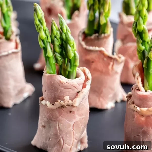 Roast Beef and Asparagus Roll Ups cut in half to make small keto appetizers
