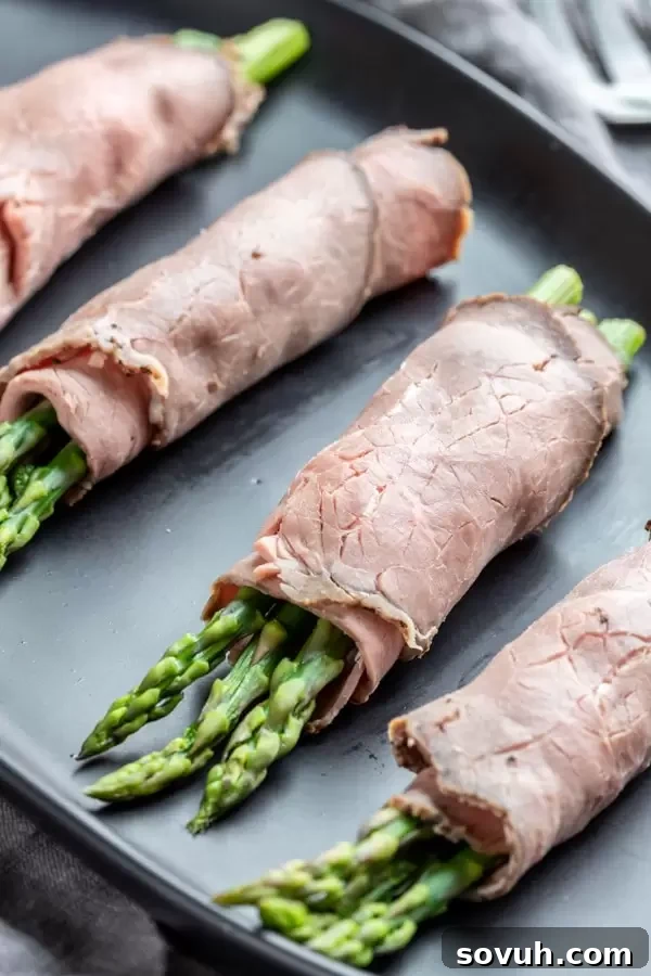 Steamed asparagus rolled up in a slice of roast beef with a creamy cream cheese spread to make Roast Beef and Asparagus Roll Ups