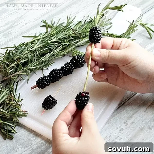 Close-up of a homemade blackberry and rosemary skewer, adding elegance to a spring cocktail.