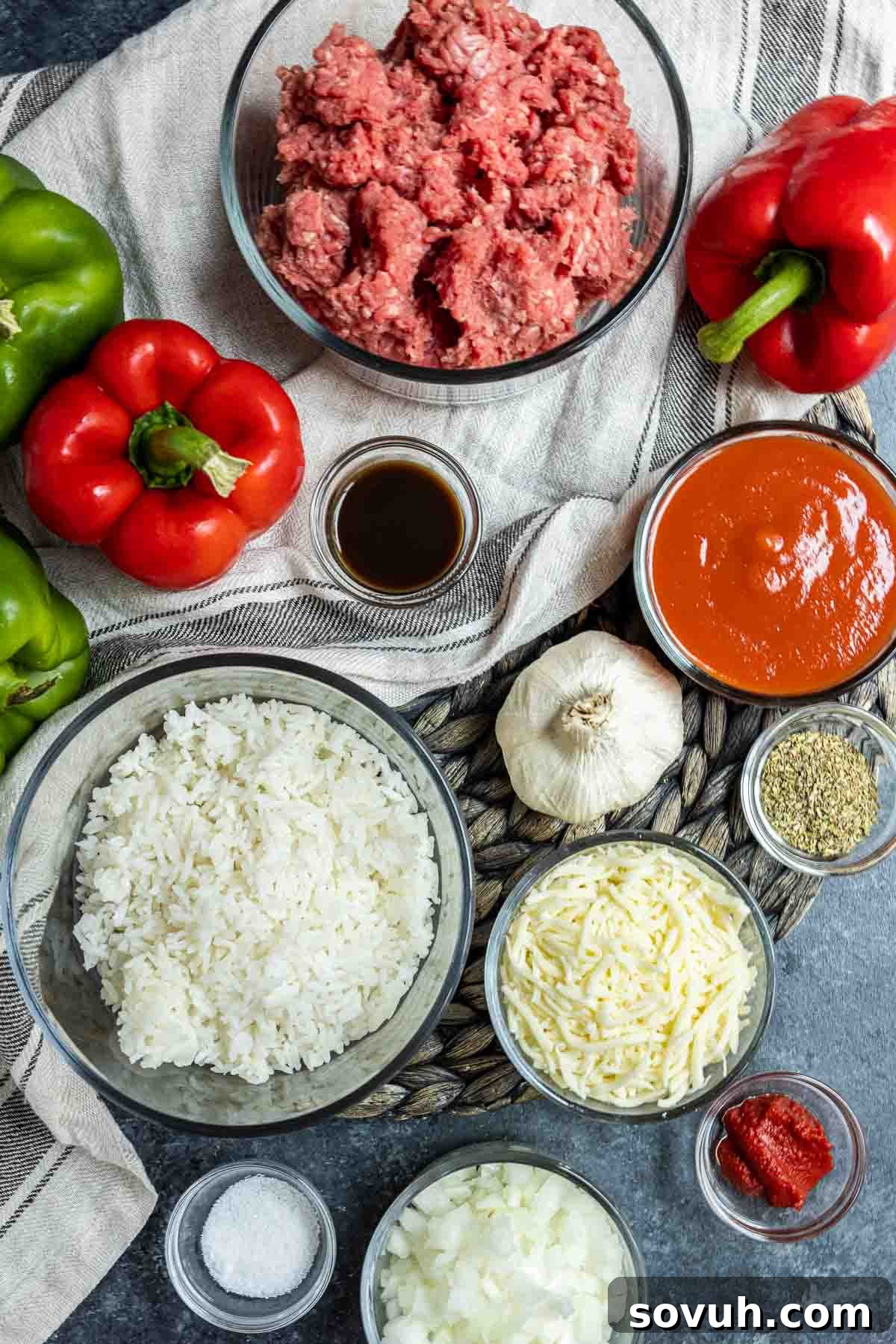 Close-up of fresh ingredients for Instant Pot Stuffed Peppers, including bell peppers, ground beef, tomato sauce, and cheese