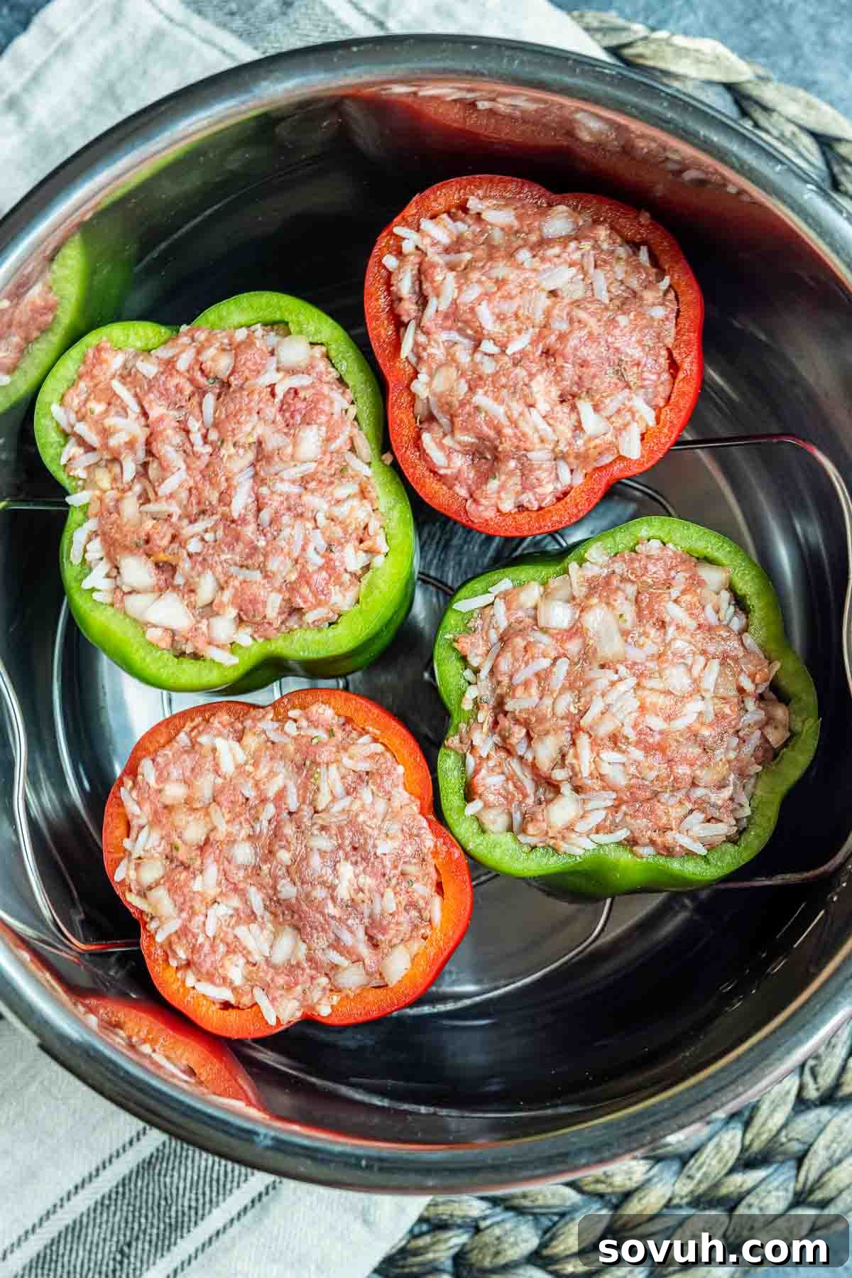 Stuffed bell peppers placed on a trivet inside an Instant Pot liner