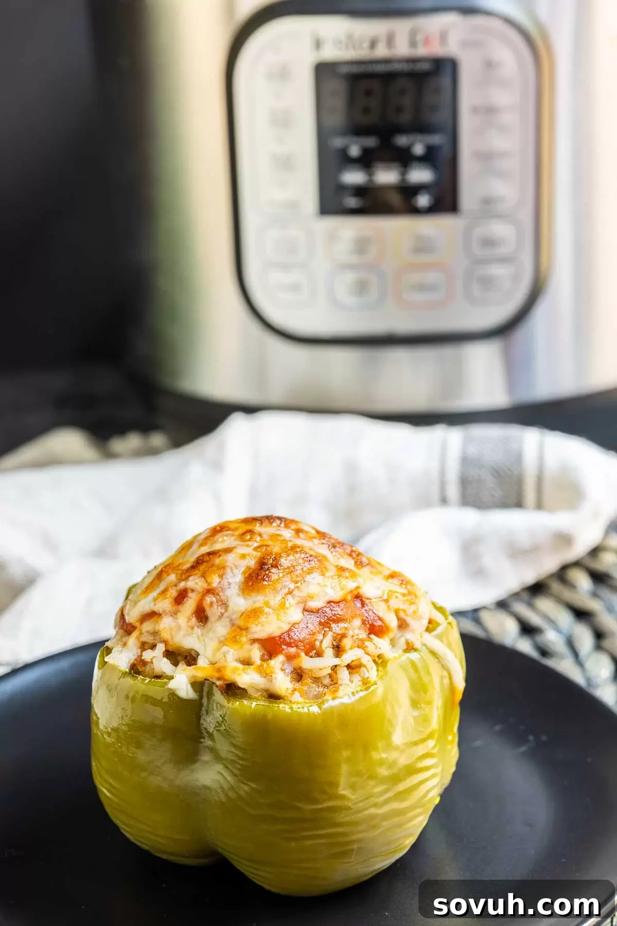 Instant Pot Stuffed Peppers with an Instant Pot in the soft-focus background