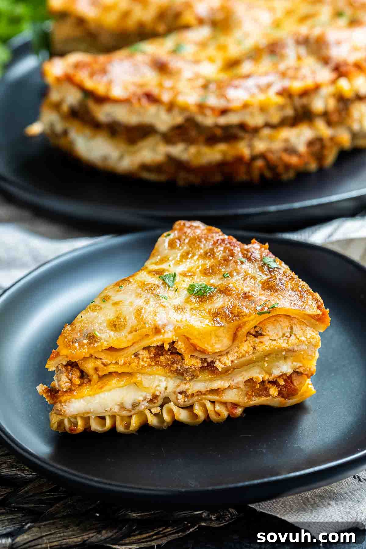 Slice of Instant Pot Lasagna on black plate