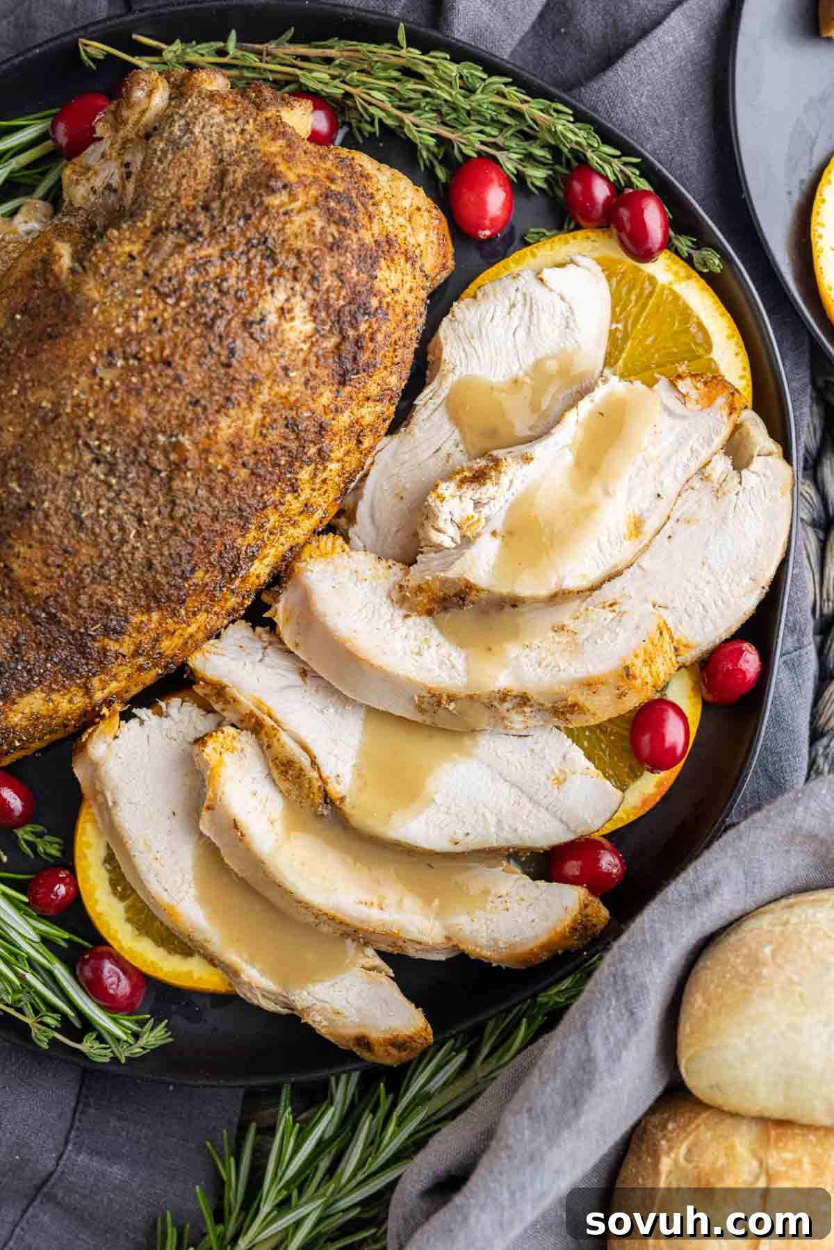 Slow Cooker Turkey Breast with gravy poured on sliced turkey breast