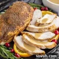 sliced Slow Cooker Turkey Breast on a plate with gravy
