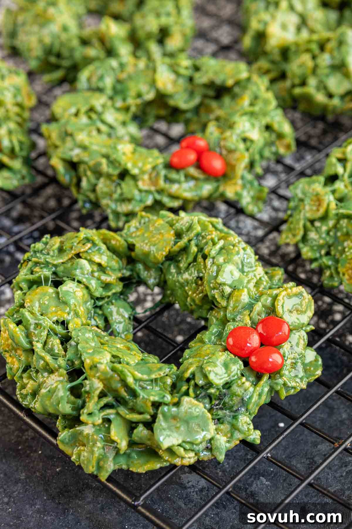 Freshly made Christmas Wreath Cookies cooling on a wire rack, ready to be enjoyed.