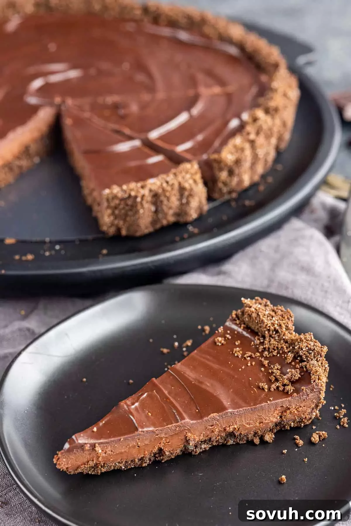 Sinful Chocolate Indulgence 5 slice of Decadent Chocolate Tart on a black plate with chocolate tart on platter
