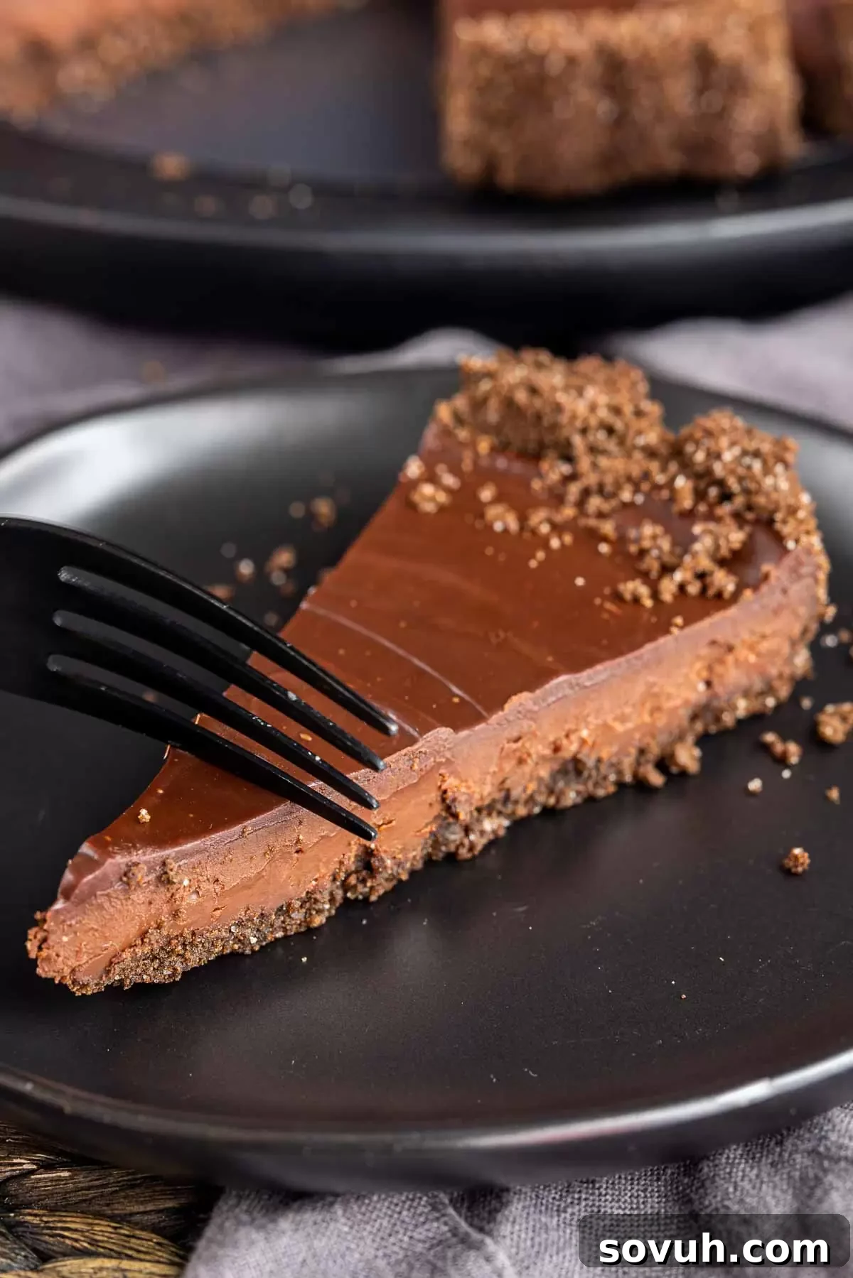 Sinful Chocolate Indulgence 6 black fork in a slice of Decadent Chocolate Tart