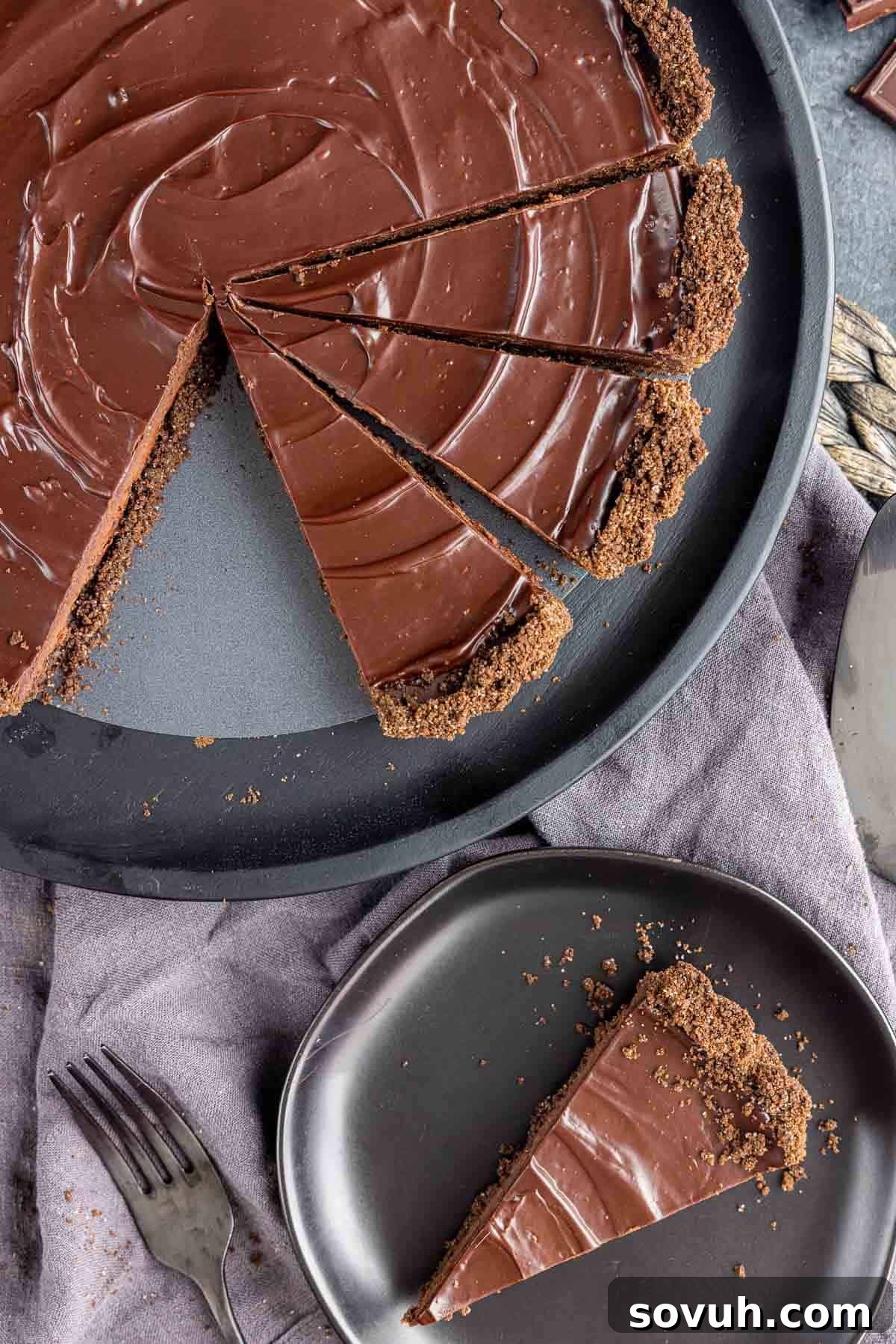 Sinful Chocolate Indulgence 7 sliced Decadent Chocolate Tart on platter and slice on black plate
