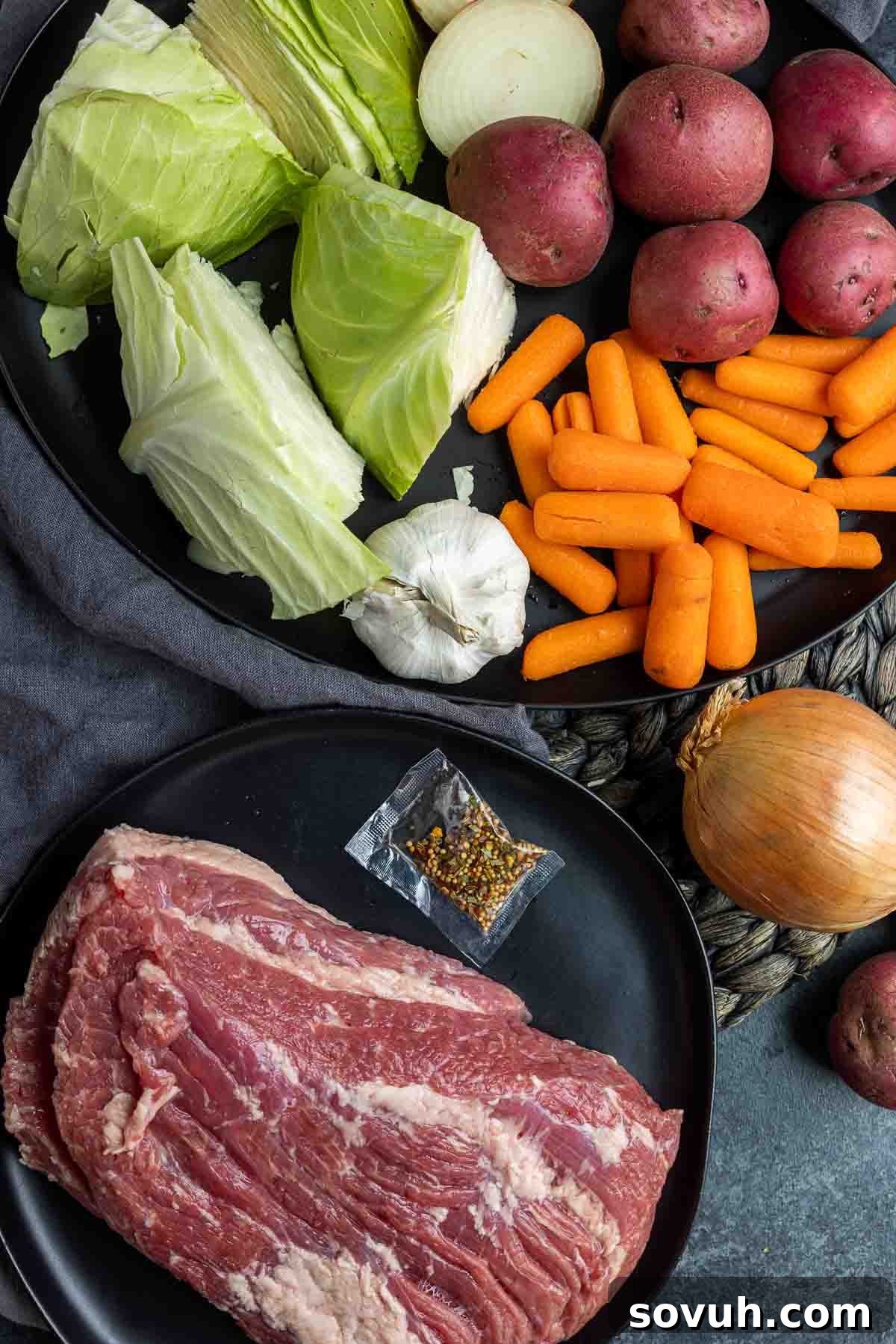 A flat lay image displaying all the fresh ingredients needed to prepare Instant Pot Corned Beef and Cabbage, including brisket, vegetables, and seasonings.