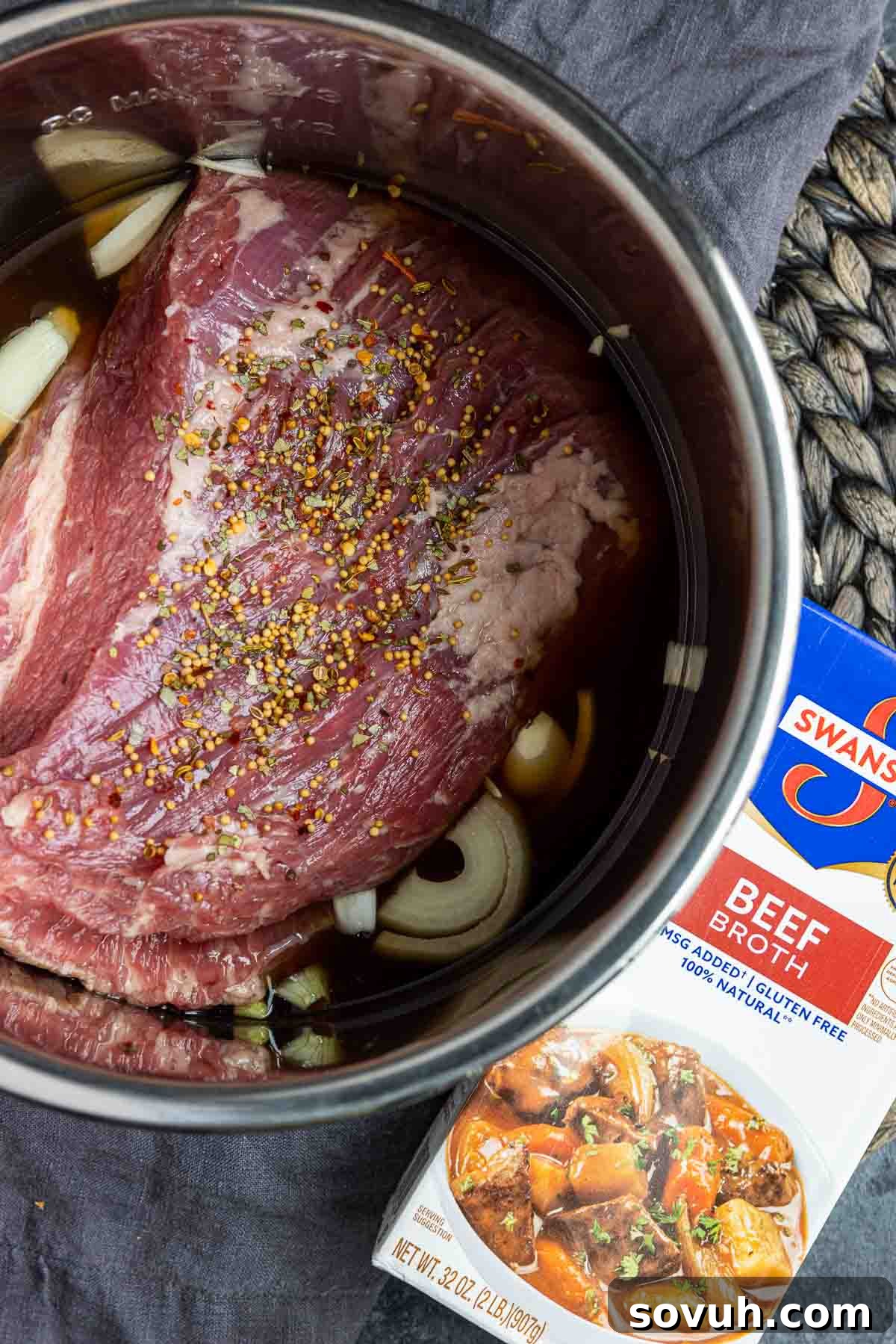 Step-by-step image showing how to layer the ingredients for Instant Pot Corned Beef, with onions and garlic at the bottom, then the brisket.