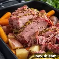 black platter with sliced Instant Pot Corned Beef with cabbage and potatoes