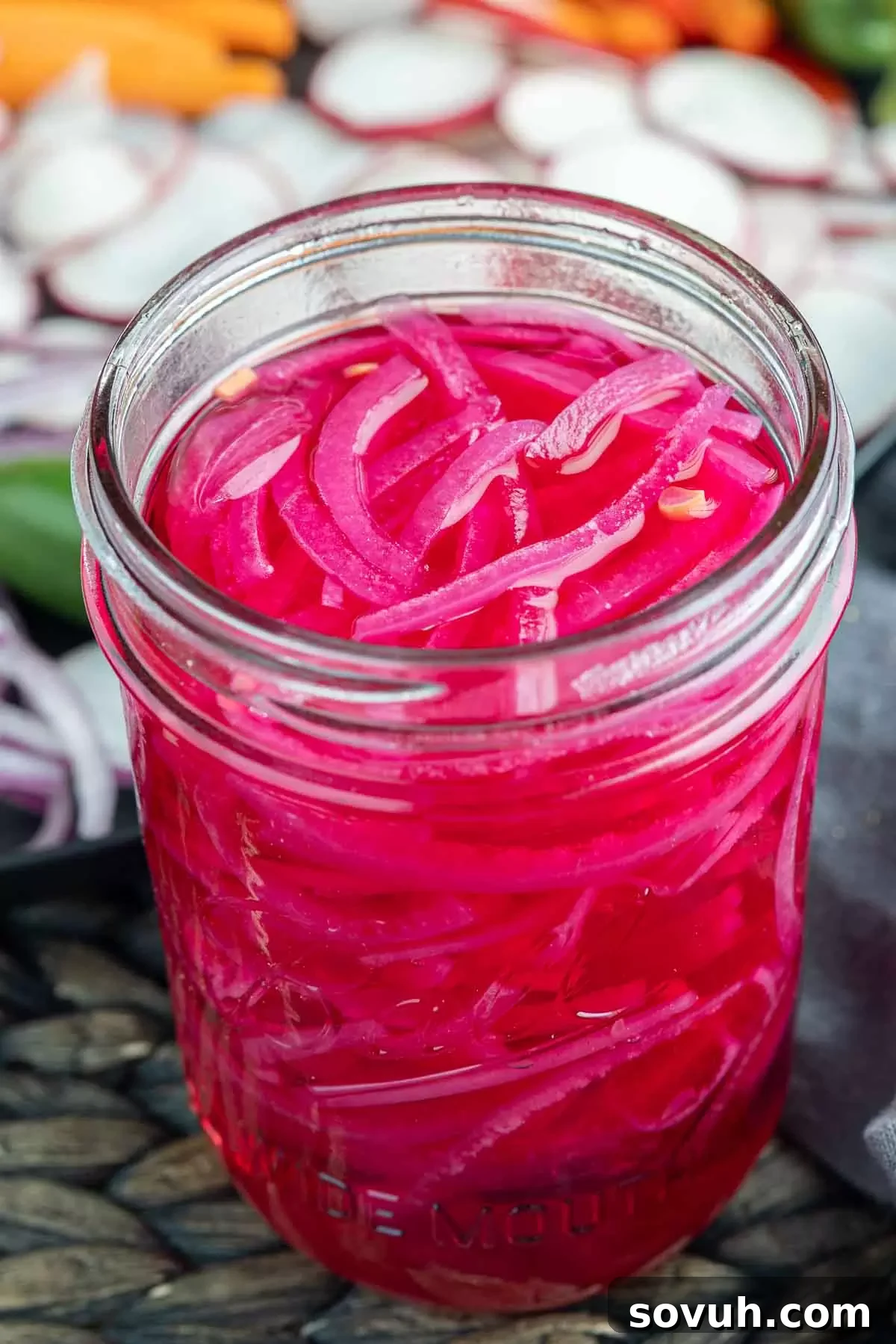 Mason jar filled with vibrant Pickled Red Onions