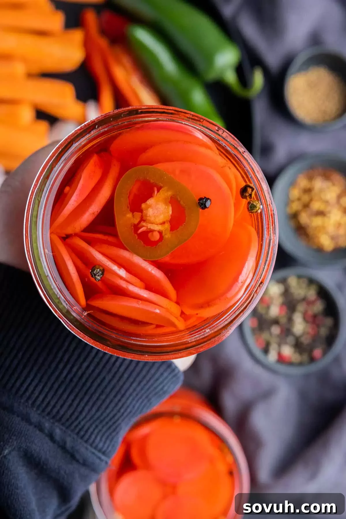 holding a jar of sliced Pickled Radishes