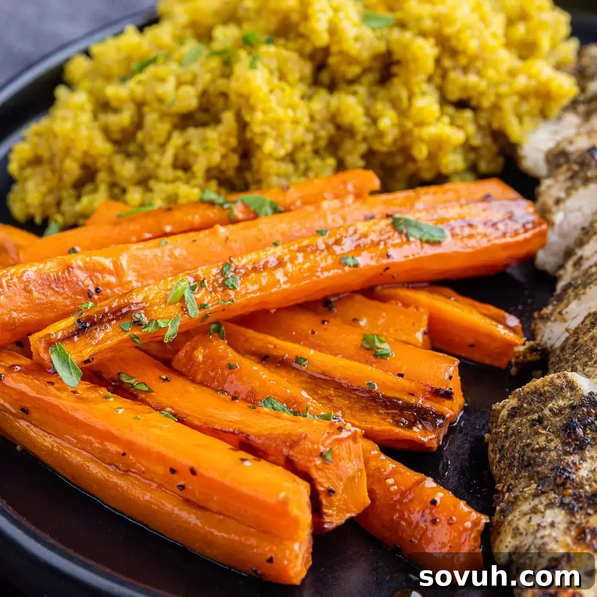 Hot Honey Roasted Carrots on a black plate