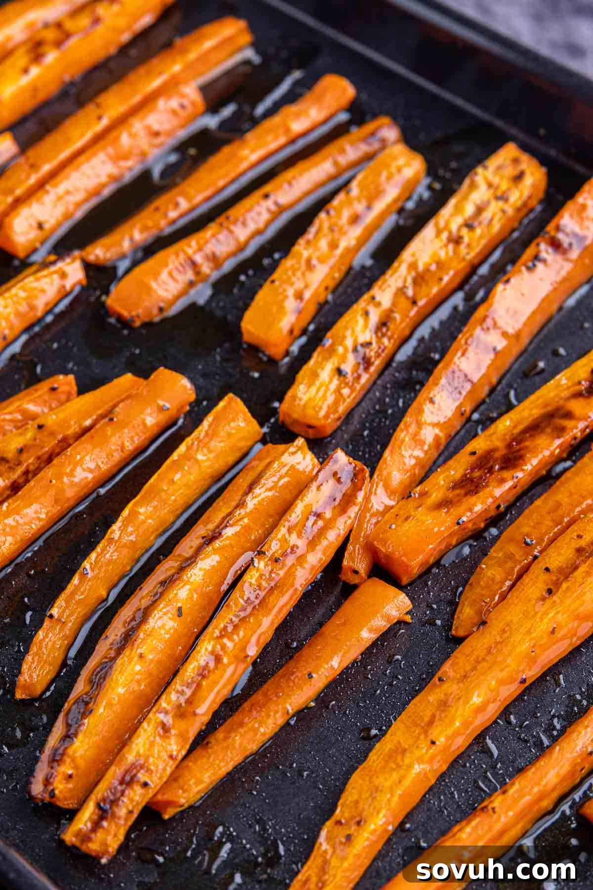 black sheet pan of Hot Honey Roasted Carrots
