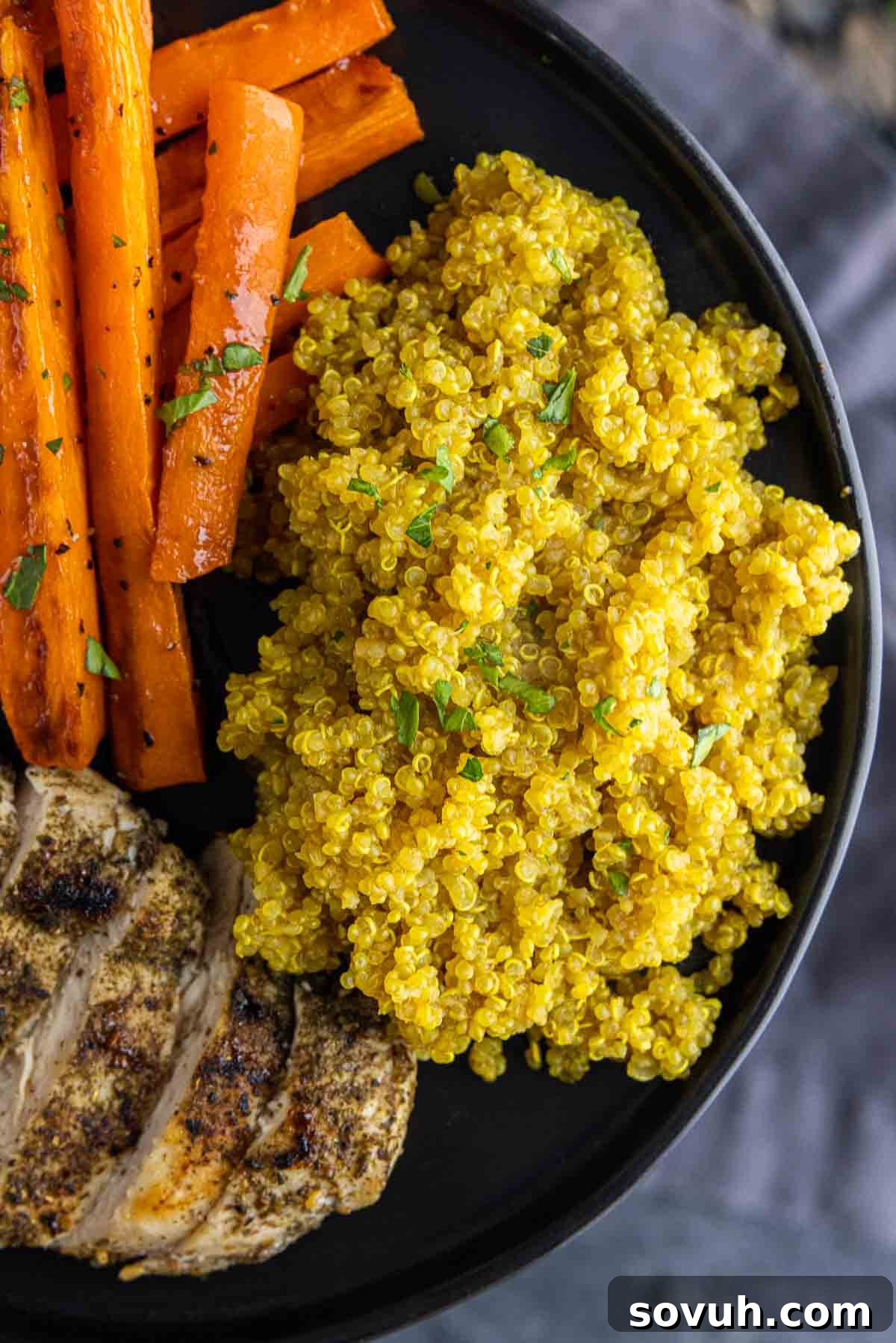 black plate with Turmeric Quinoa, carrots and chicken