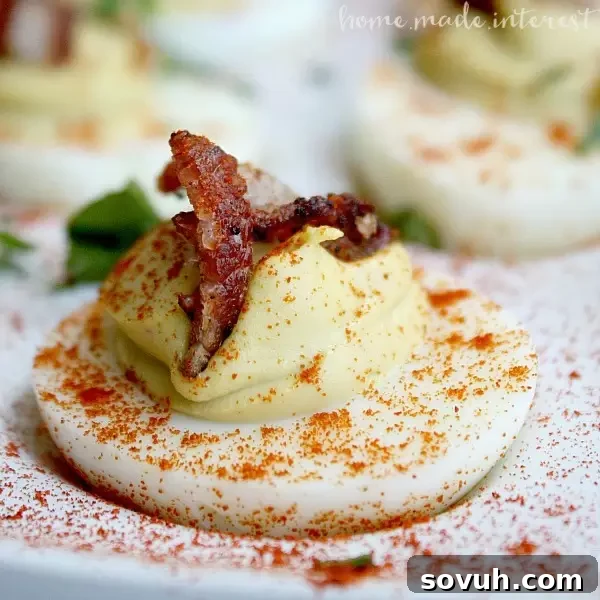 These spicy deviled eggs are a tasty twist on a classic with the zing of Sriracha, the velvety smoothness of avocado, and the saltiness of bacon. Sriracha Bacon and Avocado deviled eggs are low carb and gluten free and make a great party appetizer and Easter dinner and Easter brunch recipe!