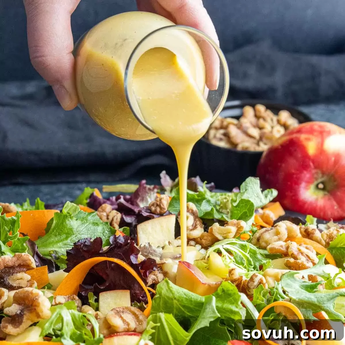Golden Honey Dijon Dressing 2 Delicious homemade honey mustard dressing being poured over a fresh salad.
