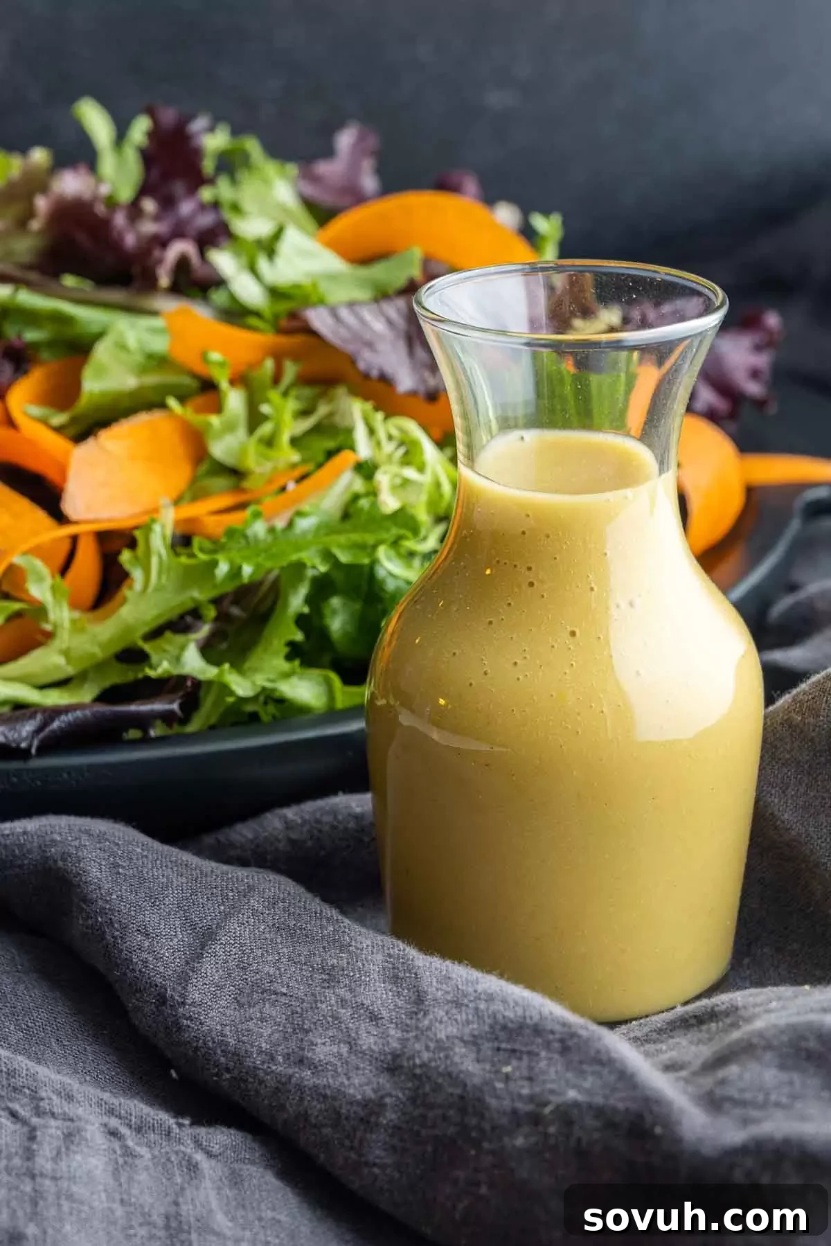 Golden Honey Dijon Dressing 4 A glass jar filled with freshly made homemade honey mustard dressing, ready for storage.