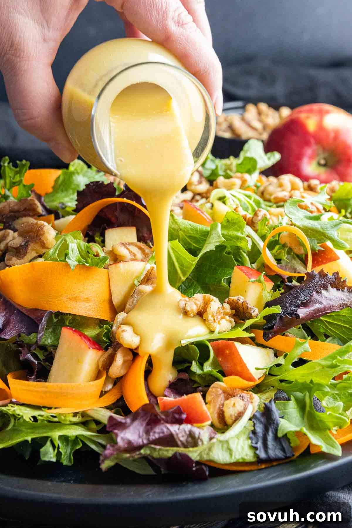 Golden Honey Dijon Dressing 5 Apple walnut salad generously drizzled with homemade honey mustard dressing, highlighting its versatility.