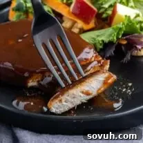 cut Air Fryer BBQ Pork Chops on a black plate