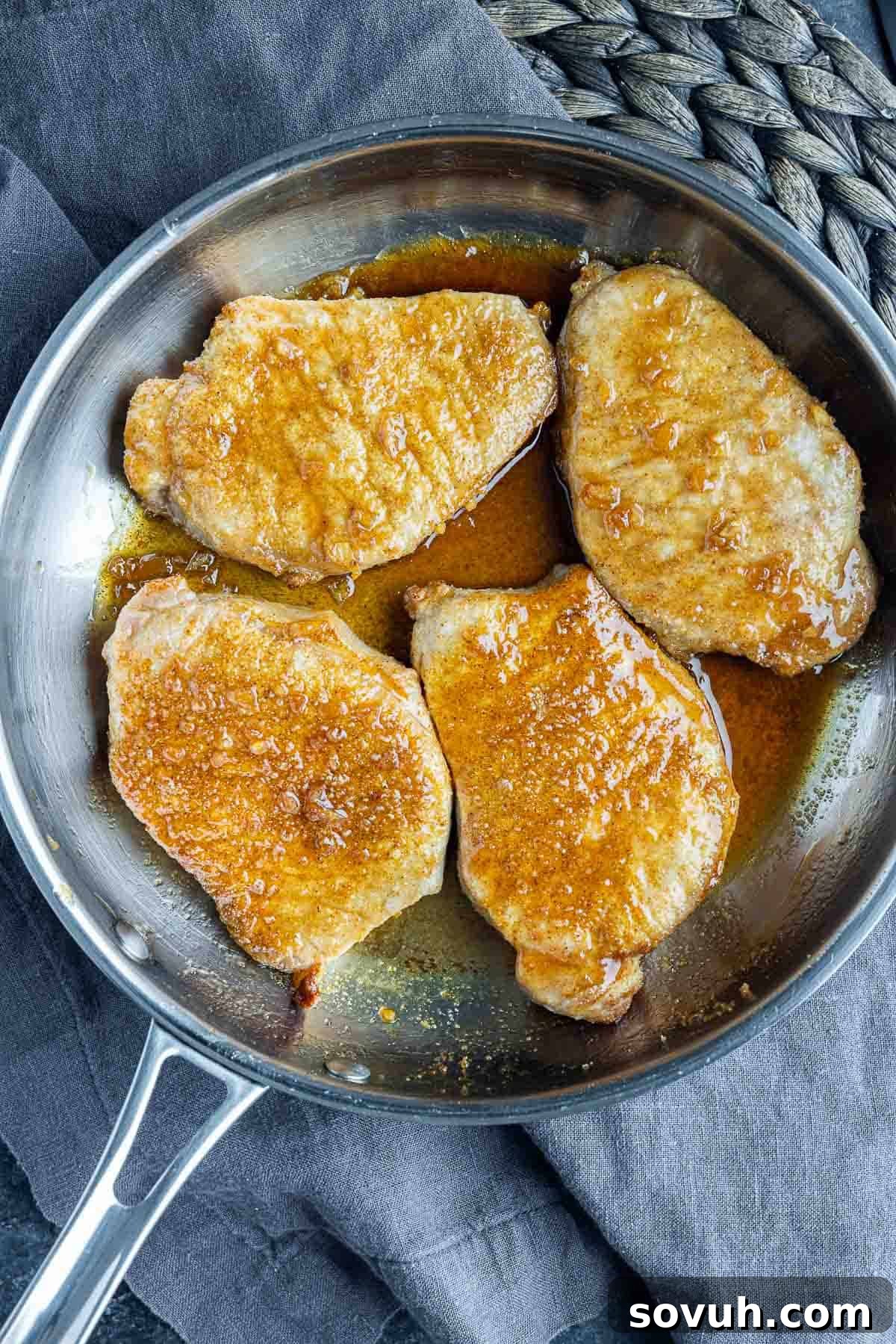 Air Fryer Honey Garlic Pork Chops in a skillet with Asian glaze