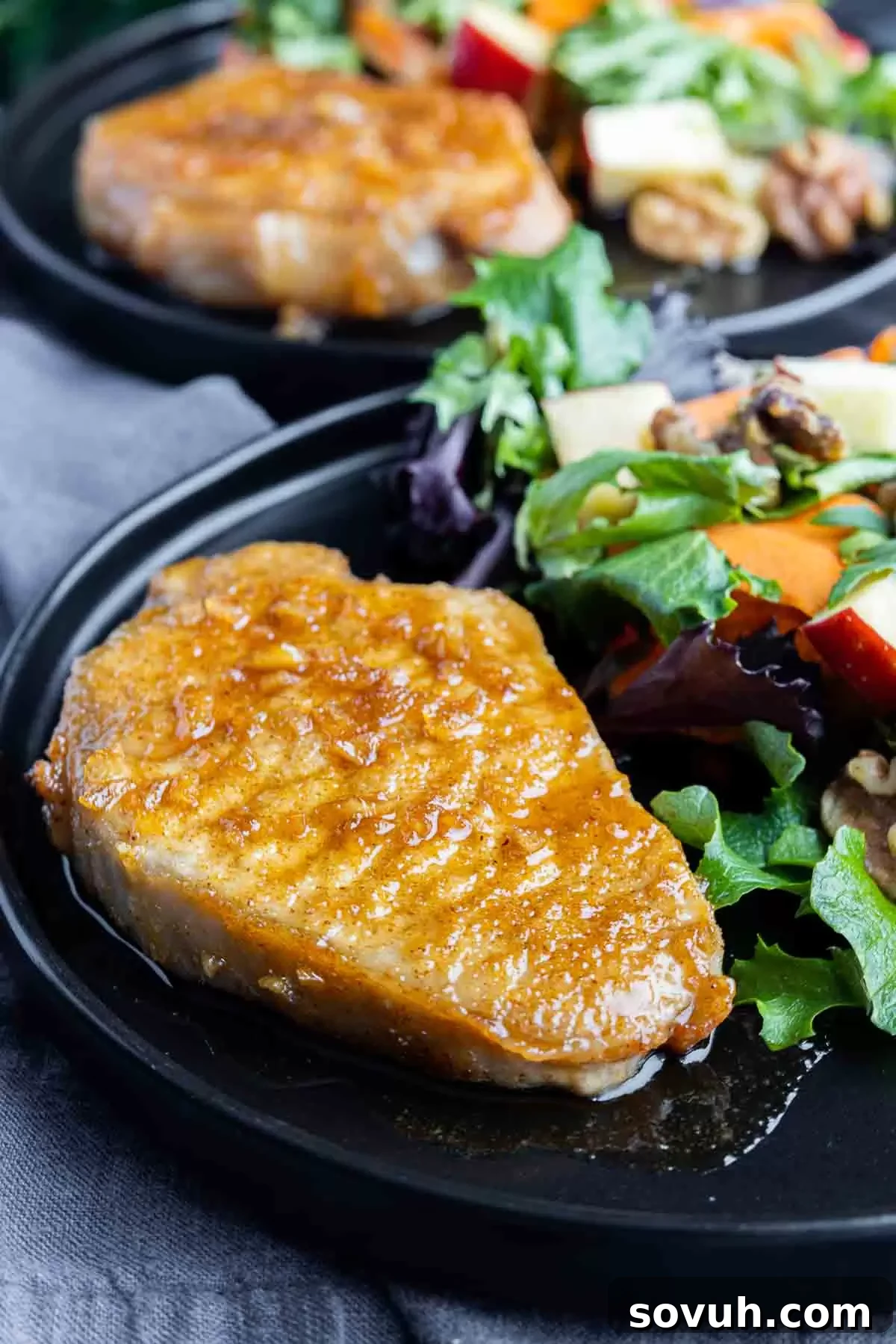 Air Fryer Honey Garlic Pork Chops on a plate with salad