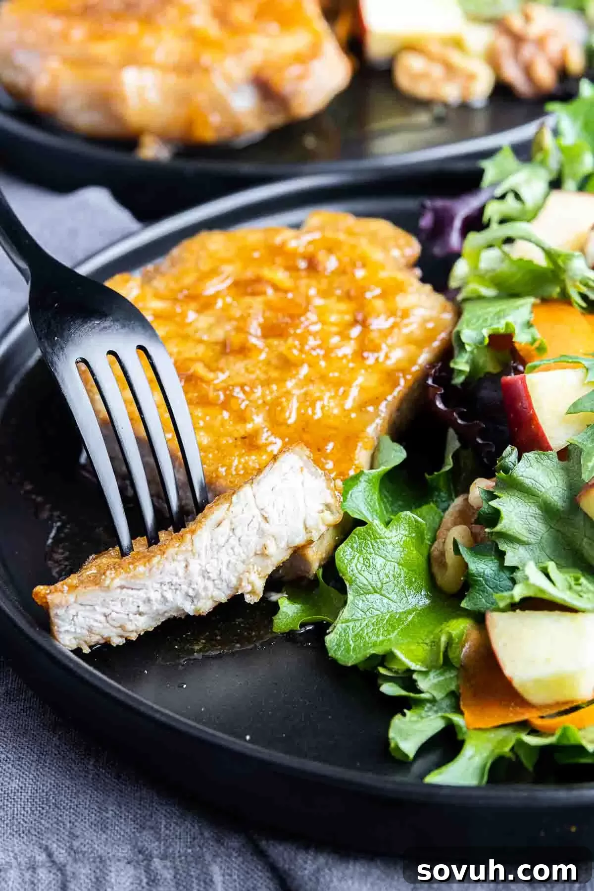 black fork with Air Fryer Honey Garlic Pork Chops on it