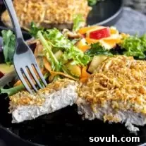 sliced Air Fryer Parmesan Crusted Pork Chops with black fork