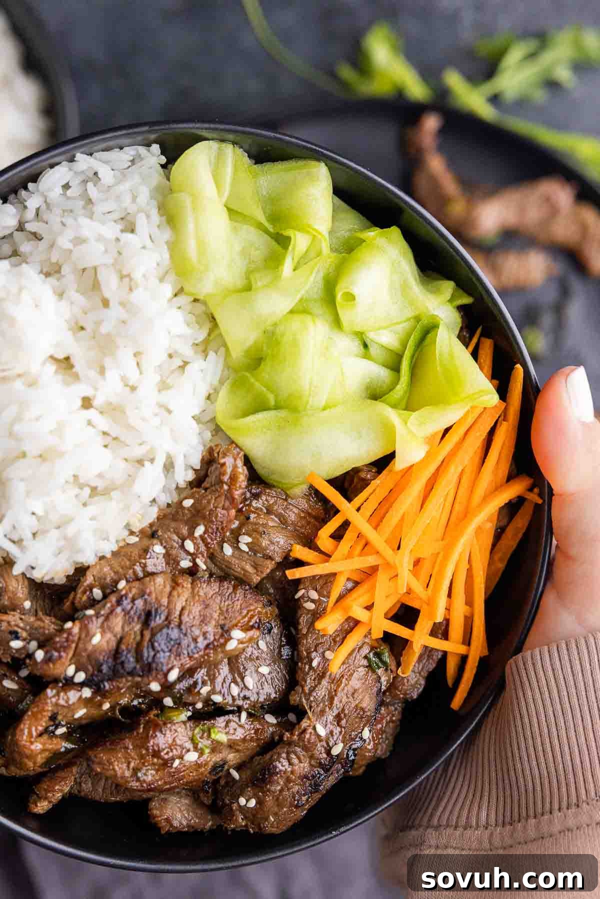 Instant Crisp Pickles 6 holding a bowl of beef bulgogi and bowl of Quick Pickled Cucumber