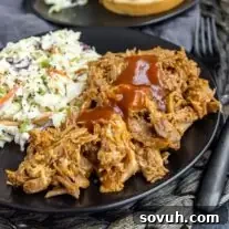 black plate with Slow Cooker BBQ Pulled Pork and coleslaw