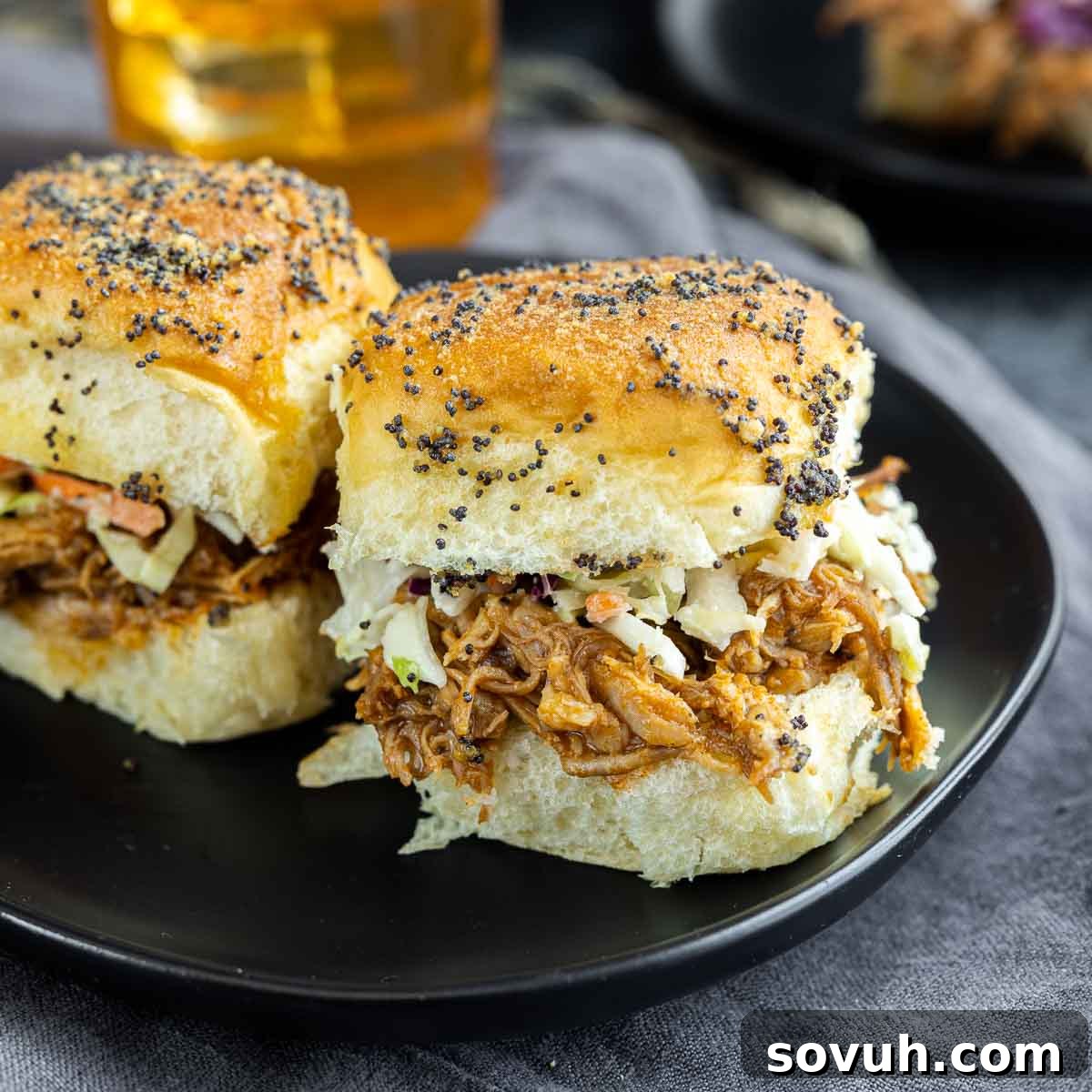 Delicious BBQ Pulled Pork Sliders on a plate, showcasing the tender pork and tangy coleslaw on toasted buns
