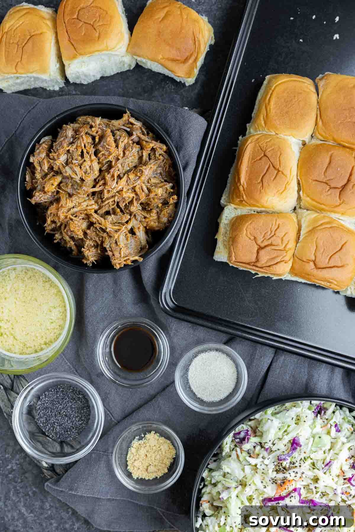 Ingredients for making BBQ Pulled Pork Sliders, including buns, pulled pork, coleslaw, butter, and spices