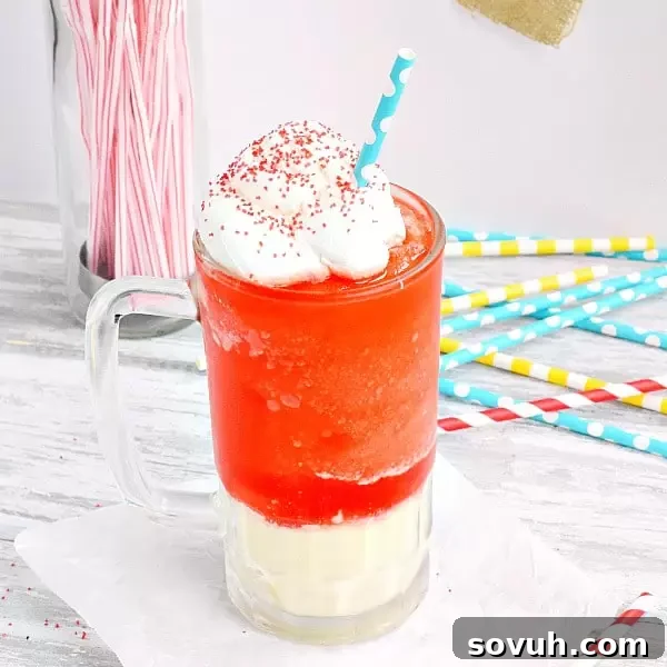 Hands holding a delicious and colorful Kool-Aid Slushie Ice Cream Float, expertly topped with a swirl of whipped cream.