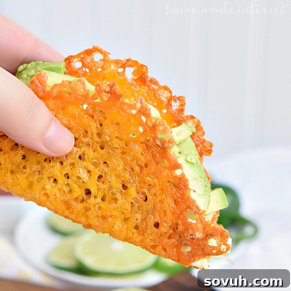 Hand holding a delicious Keto Taco made with a crispy cheese taco shell