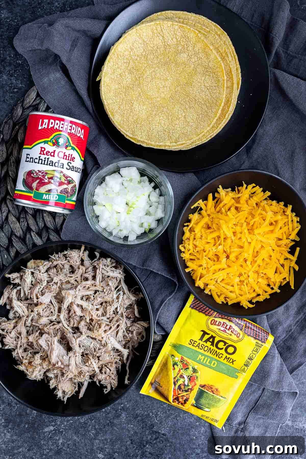 Key ingredients laid out on a counter to make a Pulled Pork Enchilada Casserole.