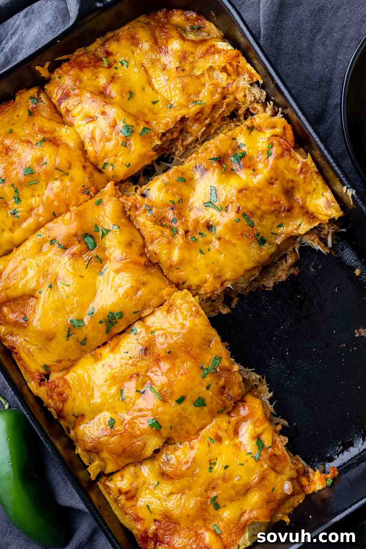 Individual serving of Pulled Pork Enchilada Casserole with melted cheese.