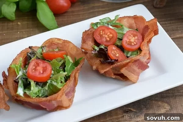 A stunning close-up of finished BLT Bacon Cups, showcasing the perfectly crispy bacon weave filled with fresh, vibrant lettuce and juicy grape tomatoes. An elegant, low-carb appetizer or meal option that's as delicious as it is beautiful.