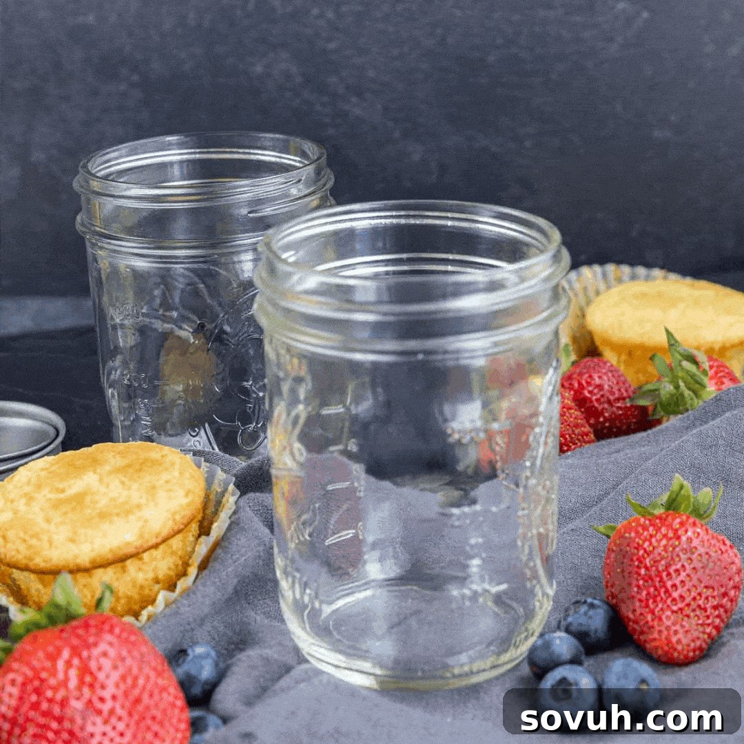 A GIF illustrating the layering process of 4th of July cupcakes in a jar: whipped cream, cupcake, fruit, repeat.