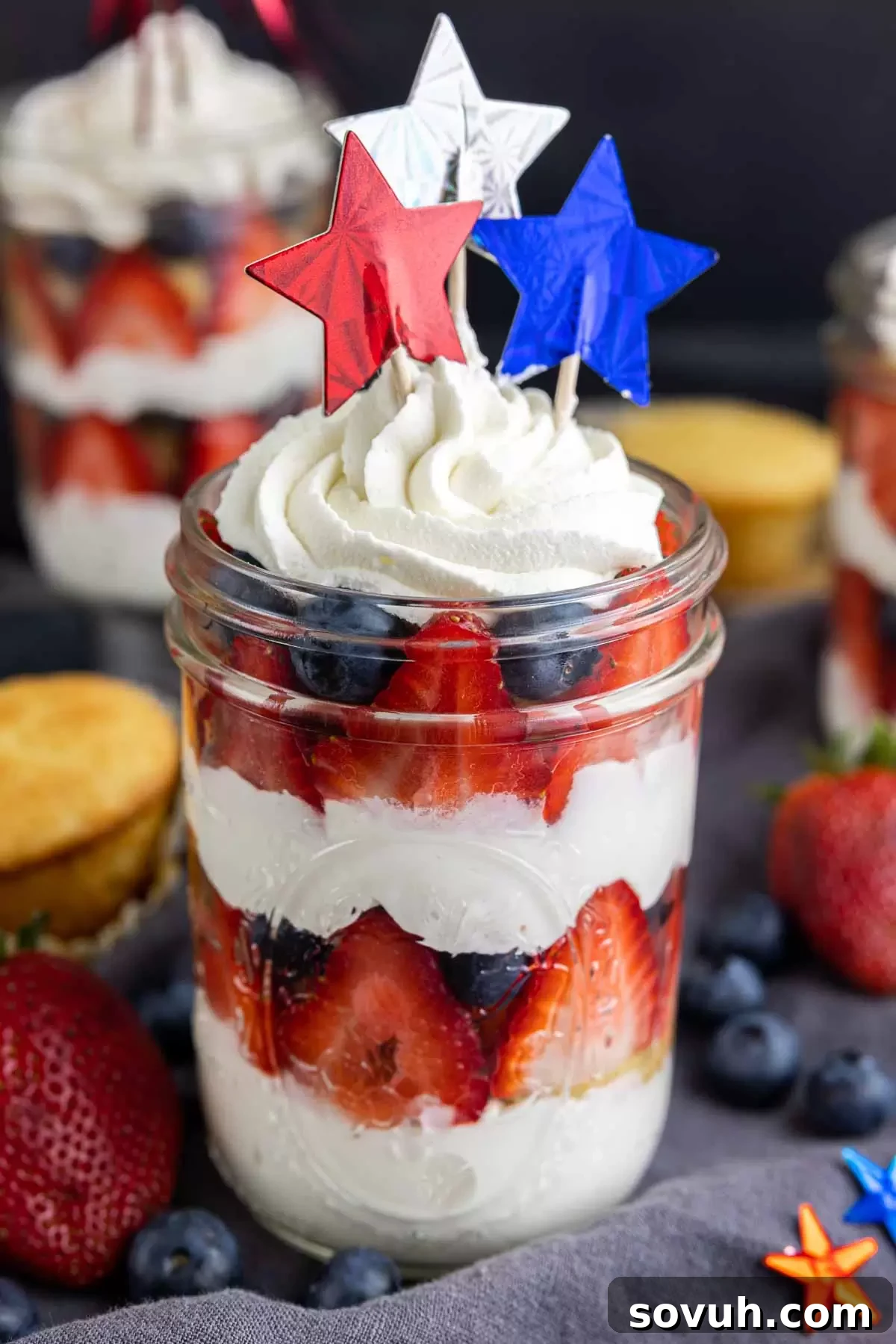 A collection of 4th of July cupcakes in a jar, topped with star sprinkles, ready for serving.