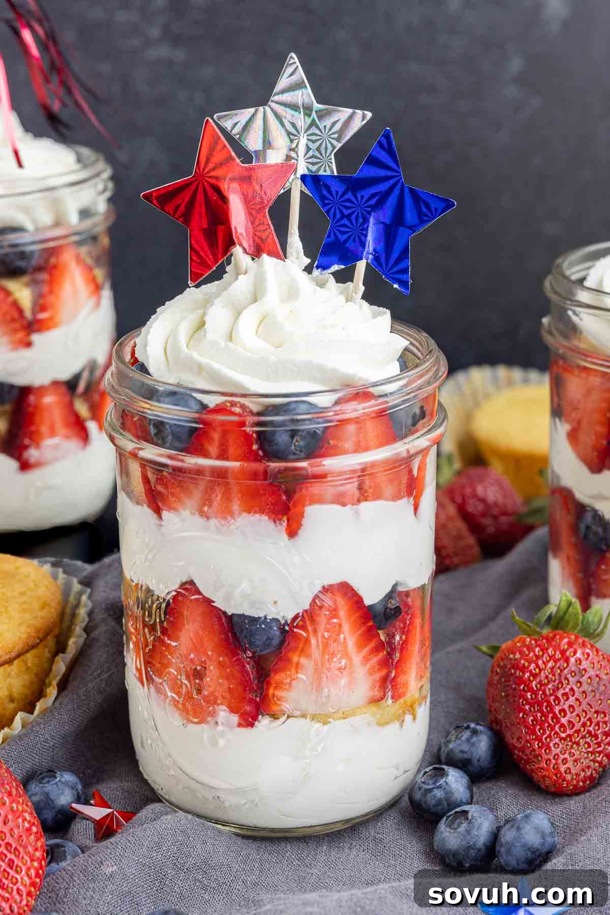 A festive display of 4th of July cupcakes in a jar, adorned with patriotic star sprinkles, perfect for a celebration.