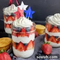 cupcakes in a jar with fresh fruit and whipped cream